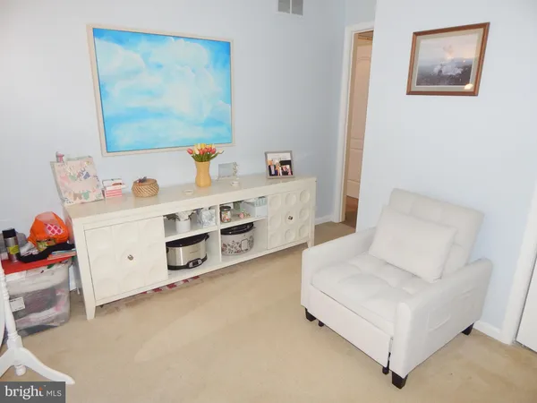 a white bed sitting in a kitchen next to a baby bed