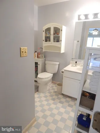 a bathroom with a sink toilet and a mirror