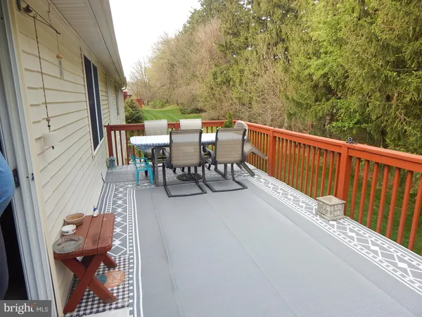 a balcony with table and chairs