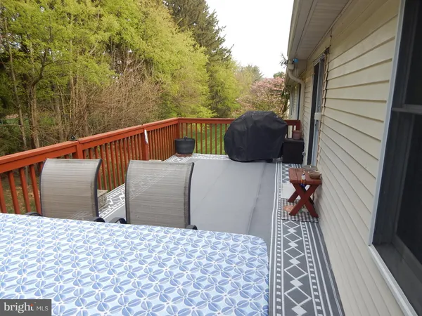 a balcony view with two chairs and wooden floor