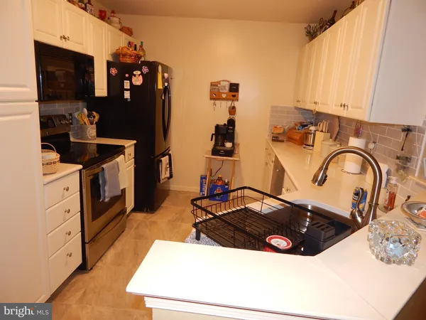 a kitchen with a sink and a stove top oven
