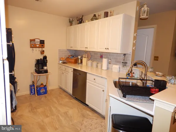 a kitchen with a sink a stove and cabinets