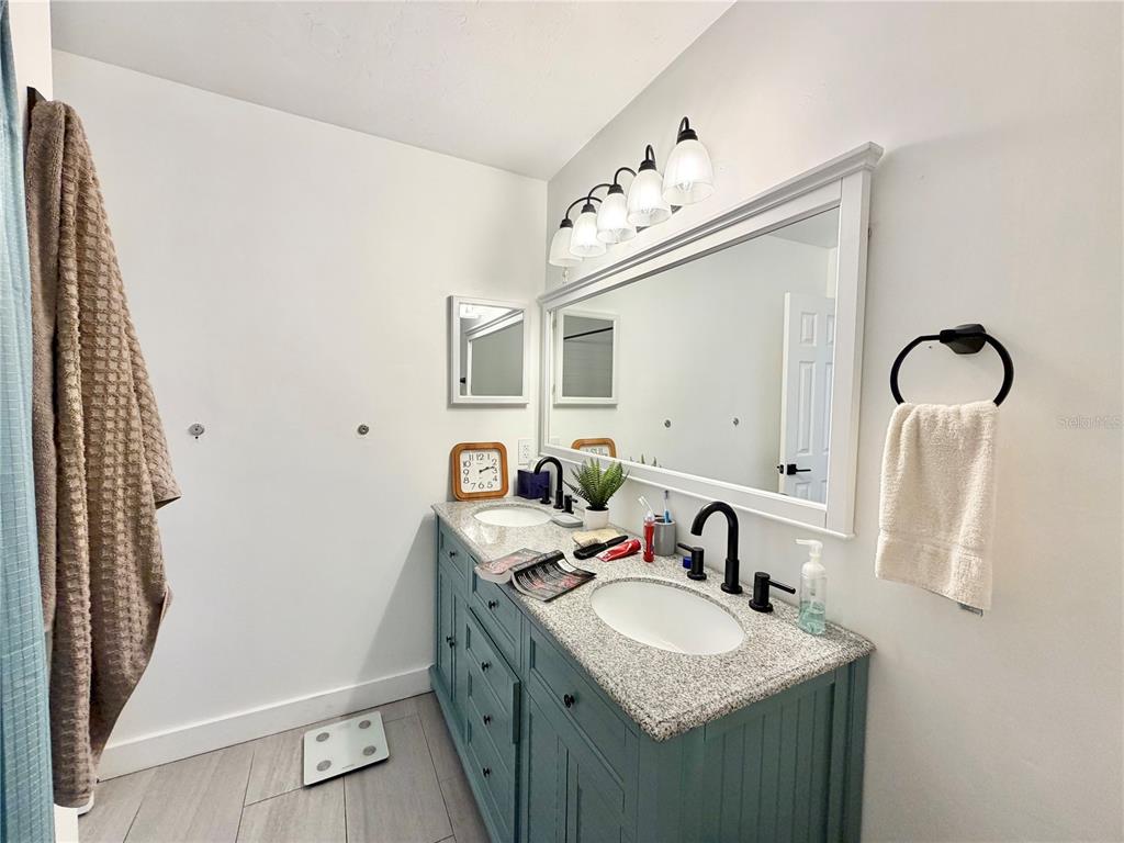 421 Northwest 48th Boulevard Gainesville, FL 32607 - Photo 11 of 26 a bathroom with a sink vanity and mirror