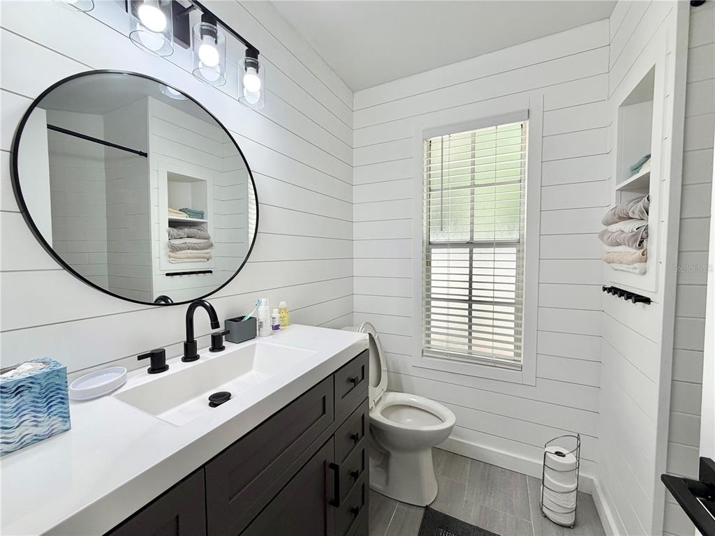 421 Northwest 48th Boulevard Gainesville, FL 32607 - Photo 15 of 26 a bathroom with a sink mirror and toilet