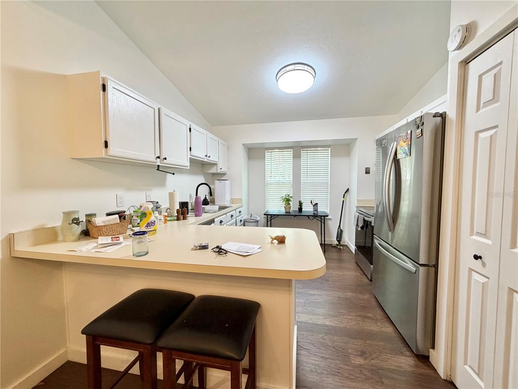 421 Northwest 48th Boulevard Gainesville, FL 32607 - Photo 2 of 26 a kitchen with a sink a refrigerator and cabinets