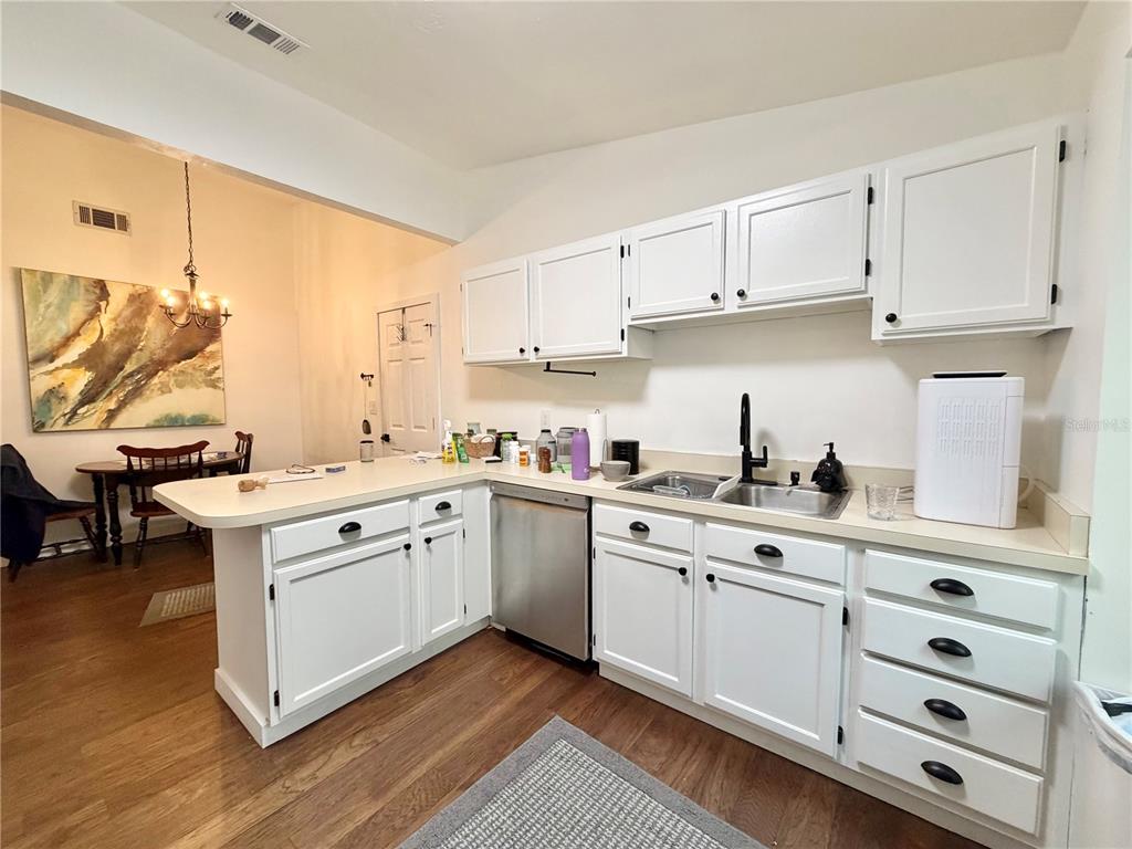 421 Northwest 48th Boulevard Gainesville, FL 32607 - Photo 3 of 26 a kitchen with granite countertop white cabinets and white appliances