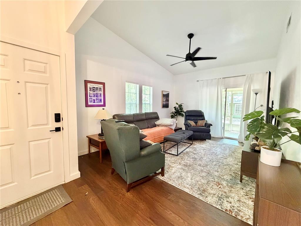 421 Northwest 48th Boulevard Gainesville, FL 32607 - Photo 6 of 26 a living room with furniture a chandelier and a window