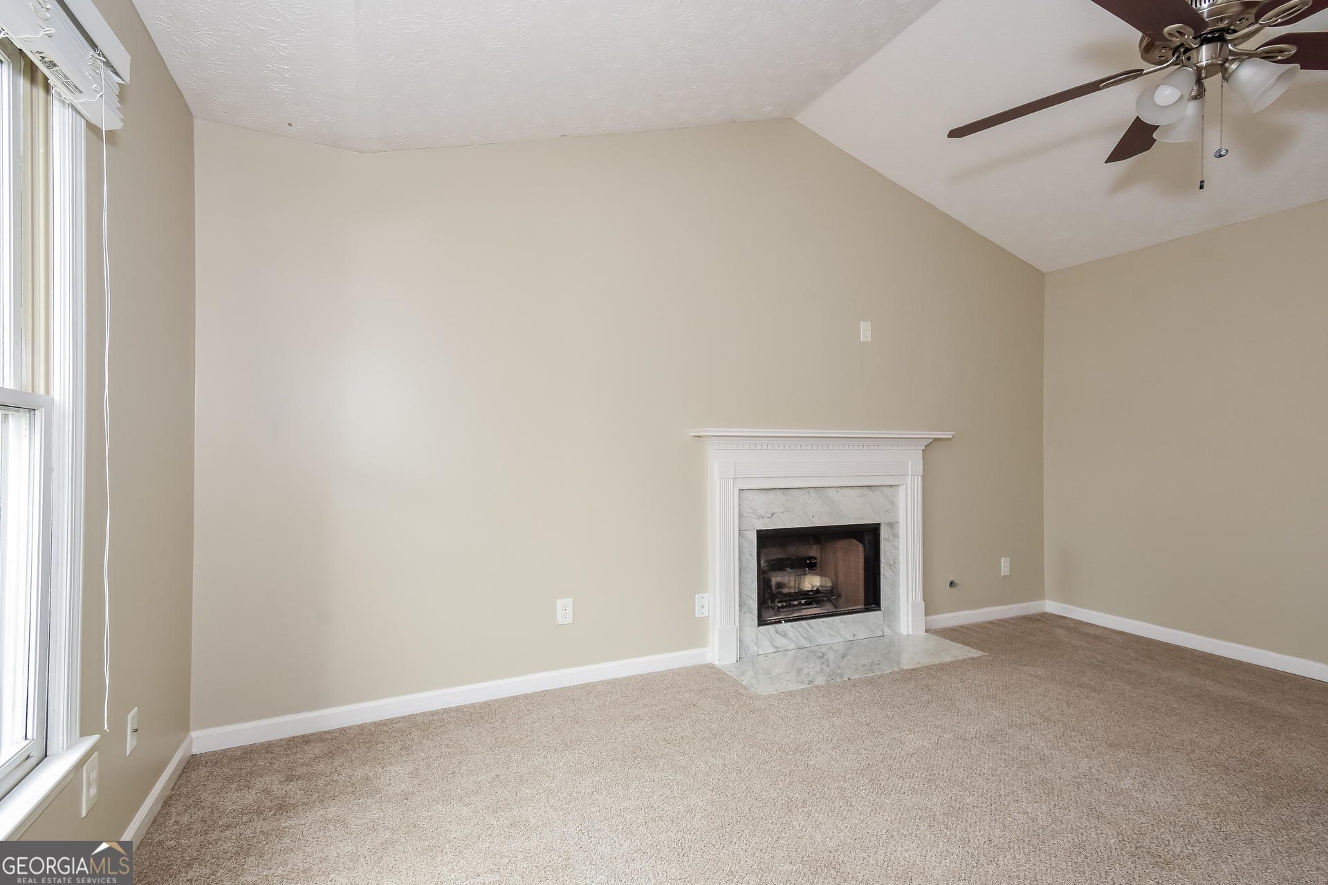 162 Aztec Way Southeast Acworth, GA 30102 - Photo 4 of 17 a view of an empty room with a fireplace and a window