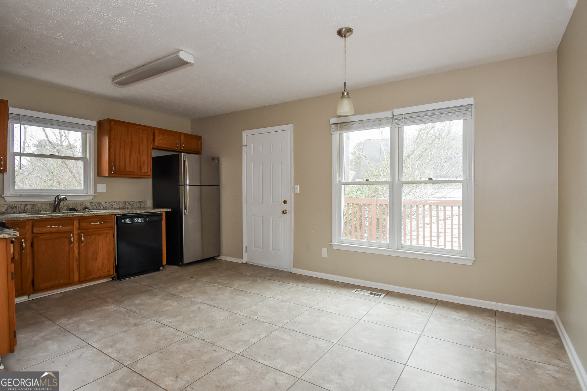 162 Aztec Way Southeast Acworth, GA 30102 - Photo 6 of 17 a kitchen with granite countertop a refrigerator and a stove top oven