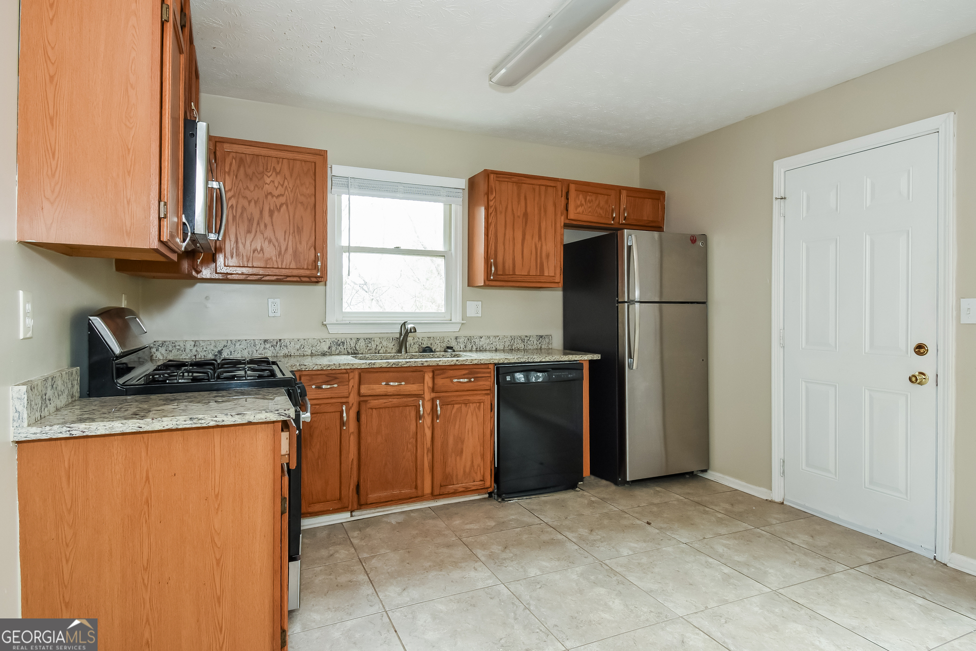 162 Aztec Way Southeast Acworth, GA 30102 - Photo 7 of 17 a kitchen with stainless steel appliances granite countertop a refrigerator stove and sink