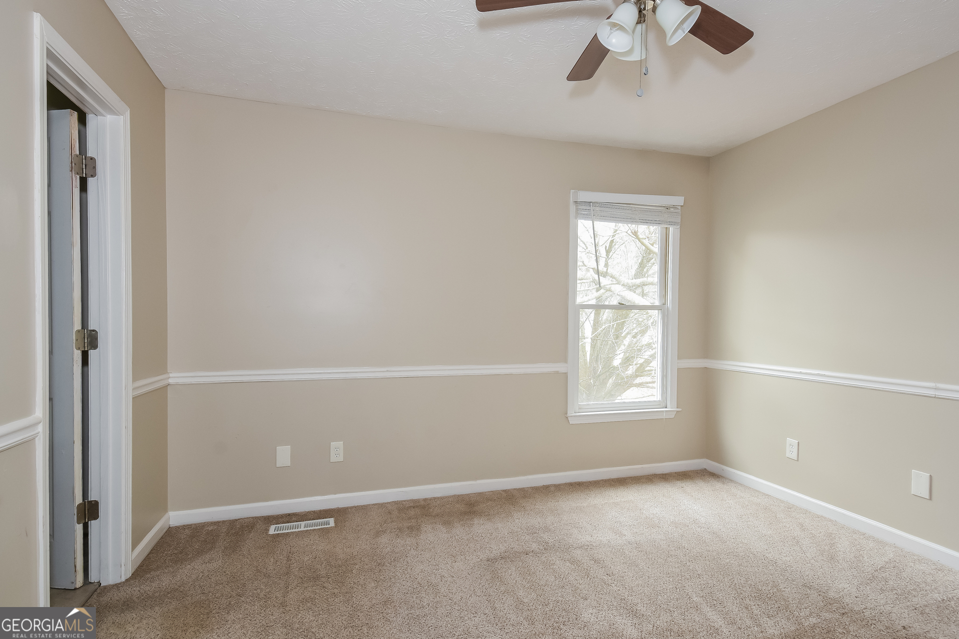 162 Aztec Way Southeast Acworth, GA 30102 - Photo 10 of 17 an empty room with a window and a fan