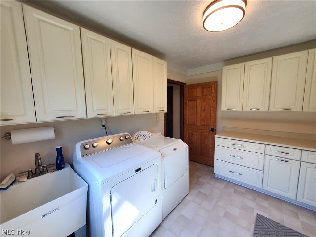 9604 Angling Road Wakeman, OH 44889 - Photo 28 of 34 Plenty of cupboards, counterspace and Laundry Tub!