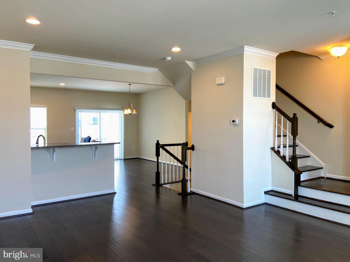 203 Quarry Point Road Malvern, PA 19355 - Photo 4 of 23 a view of a hallway with wooden floor and stairs