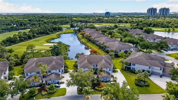 an aerial view of residential houses with outdoor space and river