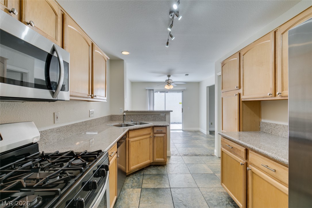 200 Luninborg Street Henderson, NV 89074 - Photo 31 of 40 A well-appointed kitchen features ample cabinetry, granite counters, and modern appliances.