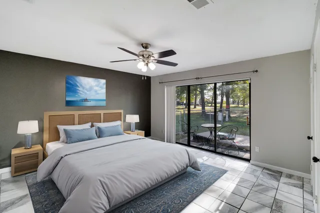 a bedroom with a large bed and a window