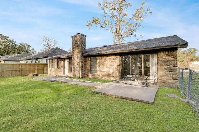 a view of a house with a yard patio and fire pit