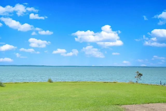 view of outdoor space with seating area and car parked