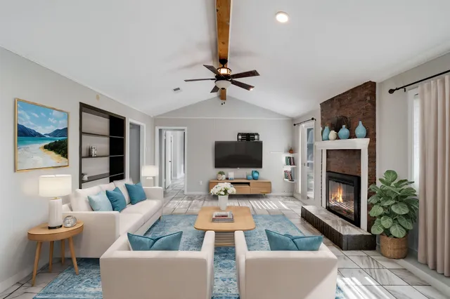 a living room with furniture a fireplace and a flat screen tv