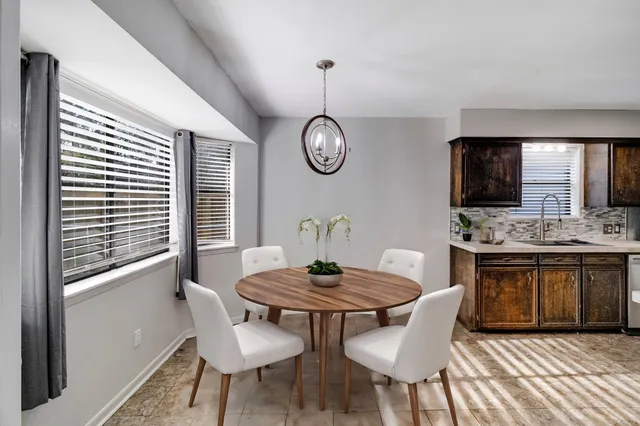 a dining room with furniture and window
