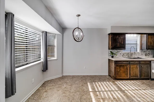 a view of kitchen with granite countertop window and a sink