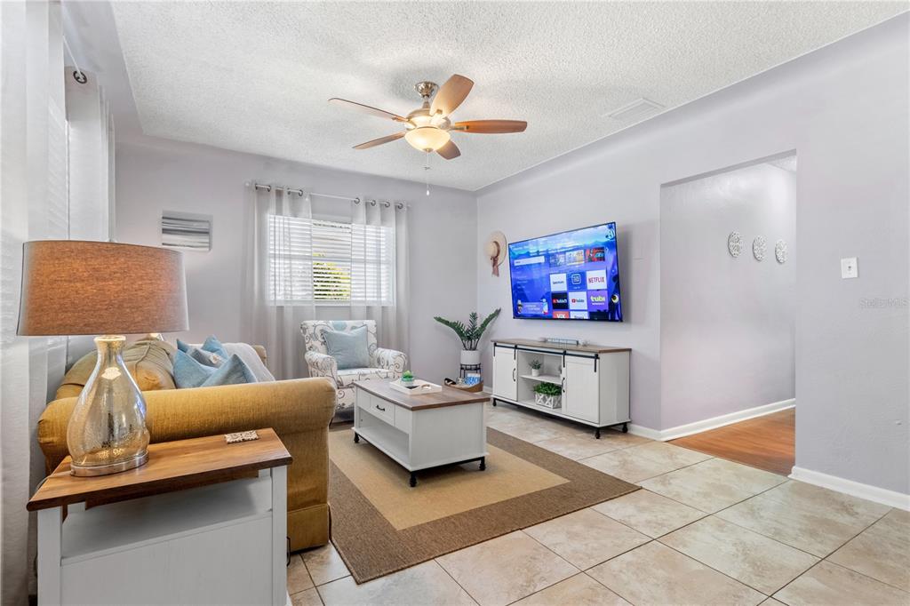 5596 100th Way North St. Petersburg, FL 33708 - Photo 3 of 67 a living room with furniture and a flat screen tv