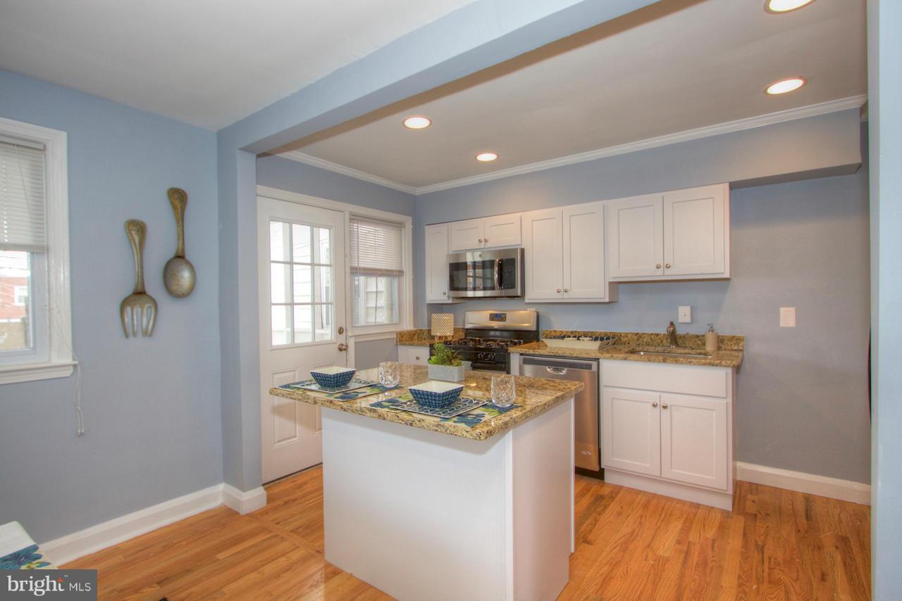 1261 Deanwood Road Baltimore, MD 21234 - Photo 2 of 22 a kitchen with granite countertop cabinets stainless steel appliances a sink and a window