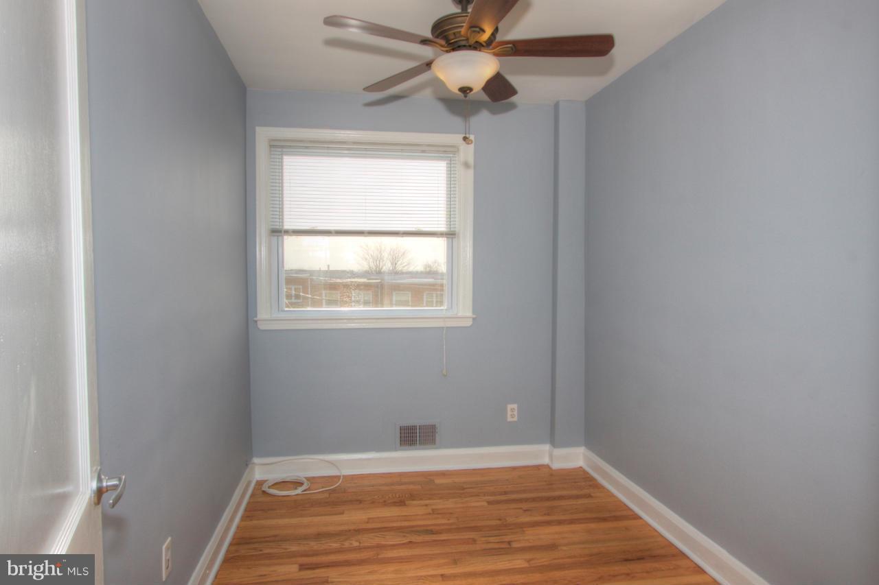 1261 Deanwood Road Baltimore, MD 21234 - Photo 14 of 22 a view of an empty room with wooden floor and a window