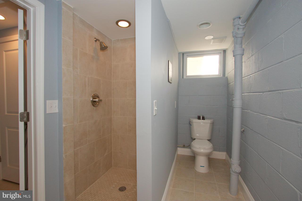 1261 Deanwood Road Baltimore, MD 21234 - Photo 16 of 22 a bathroom with a toilet sink and shower