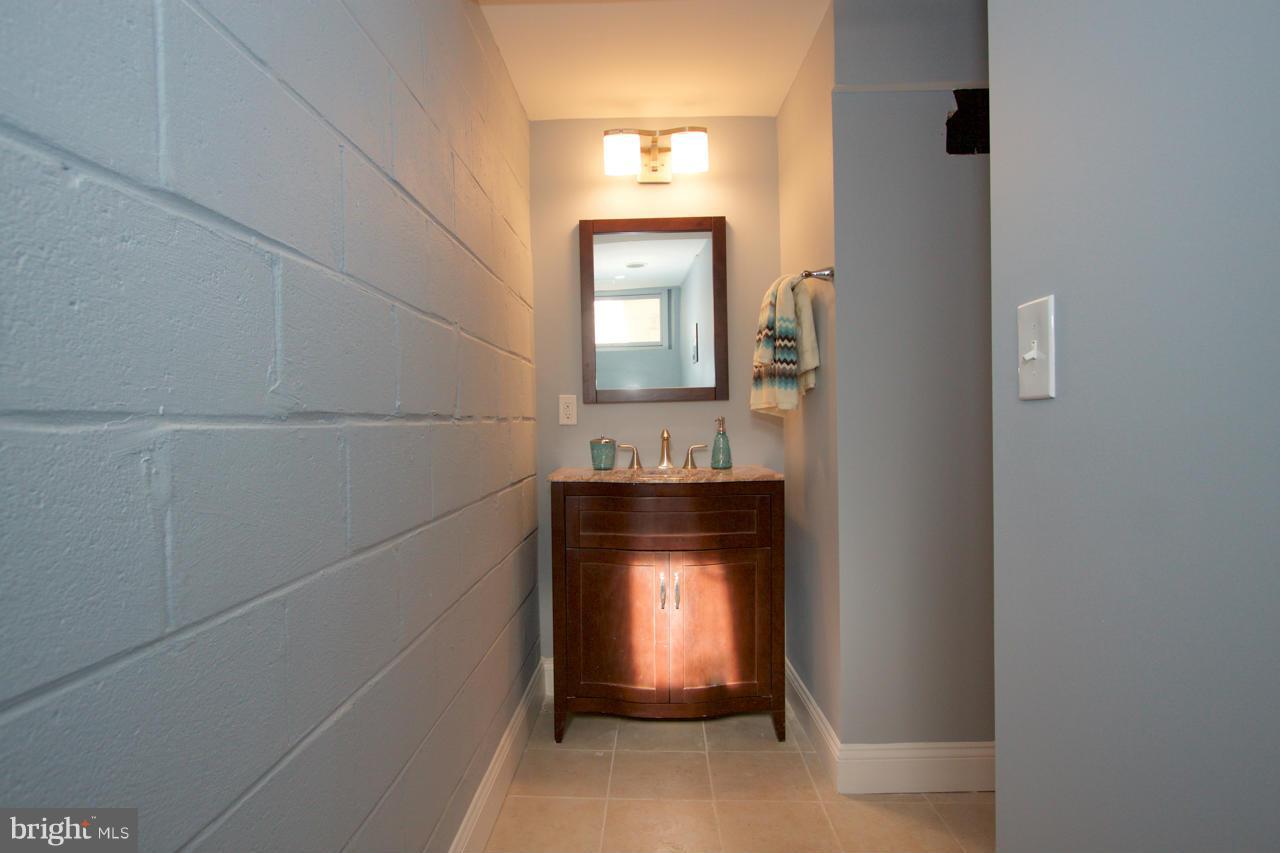 1261 Deanwood Road Baltimore, MD 21234 - Photo 18 of 22 a bathroom with a sink and a mirror