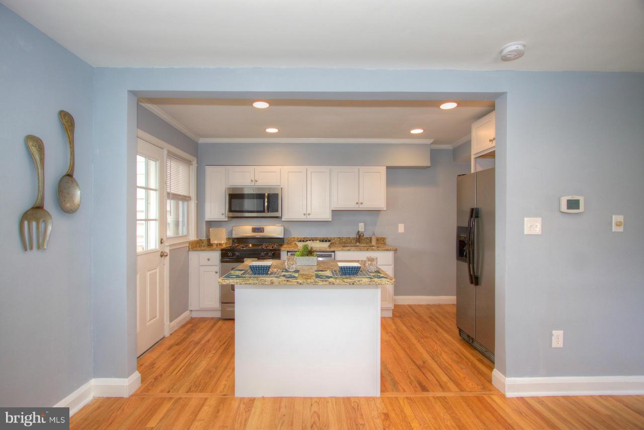 1261 Deanwood Road Baltimore, MD 21234 - Photo 6 of 22 a kitchen with stainless steel appliances granite countertop a refrigerator a stove top oven a sink and dishwasher