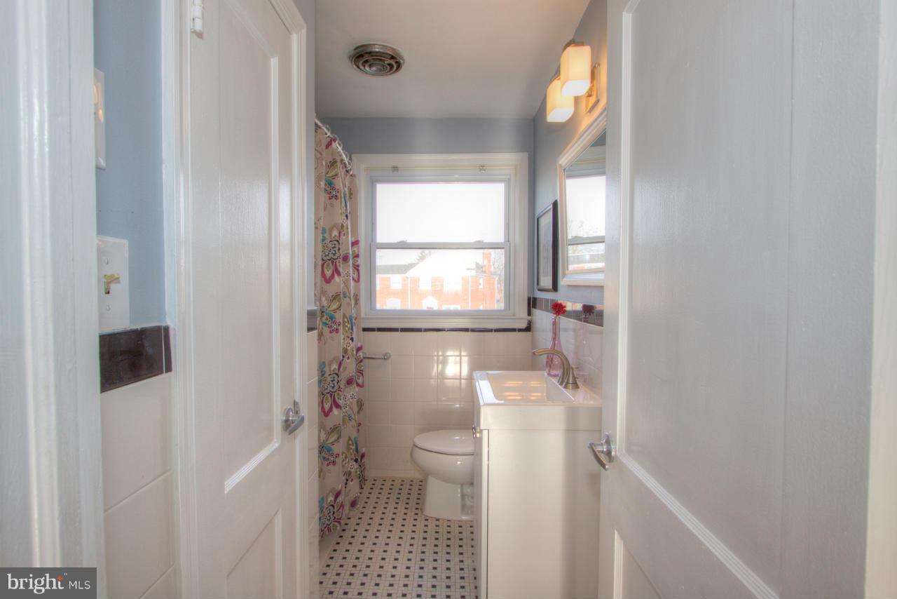 1261 Deanwood Road Baltimore, MD 21234 - Photo 10 of 22 a bathroom with a sink toilet and shower