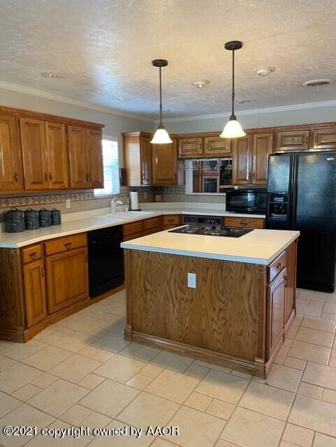 5003 Parker Street Amarillo, TX 79110 - Photo 6 of 20 a kitchen with stainless steel appliances granite countertop a sink counter space cabinets and a window