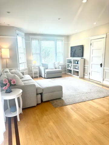 a spacious bedroom with a bed and glass windows