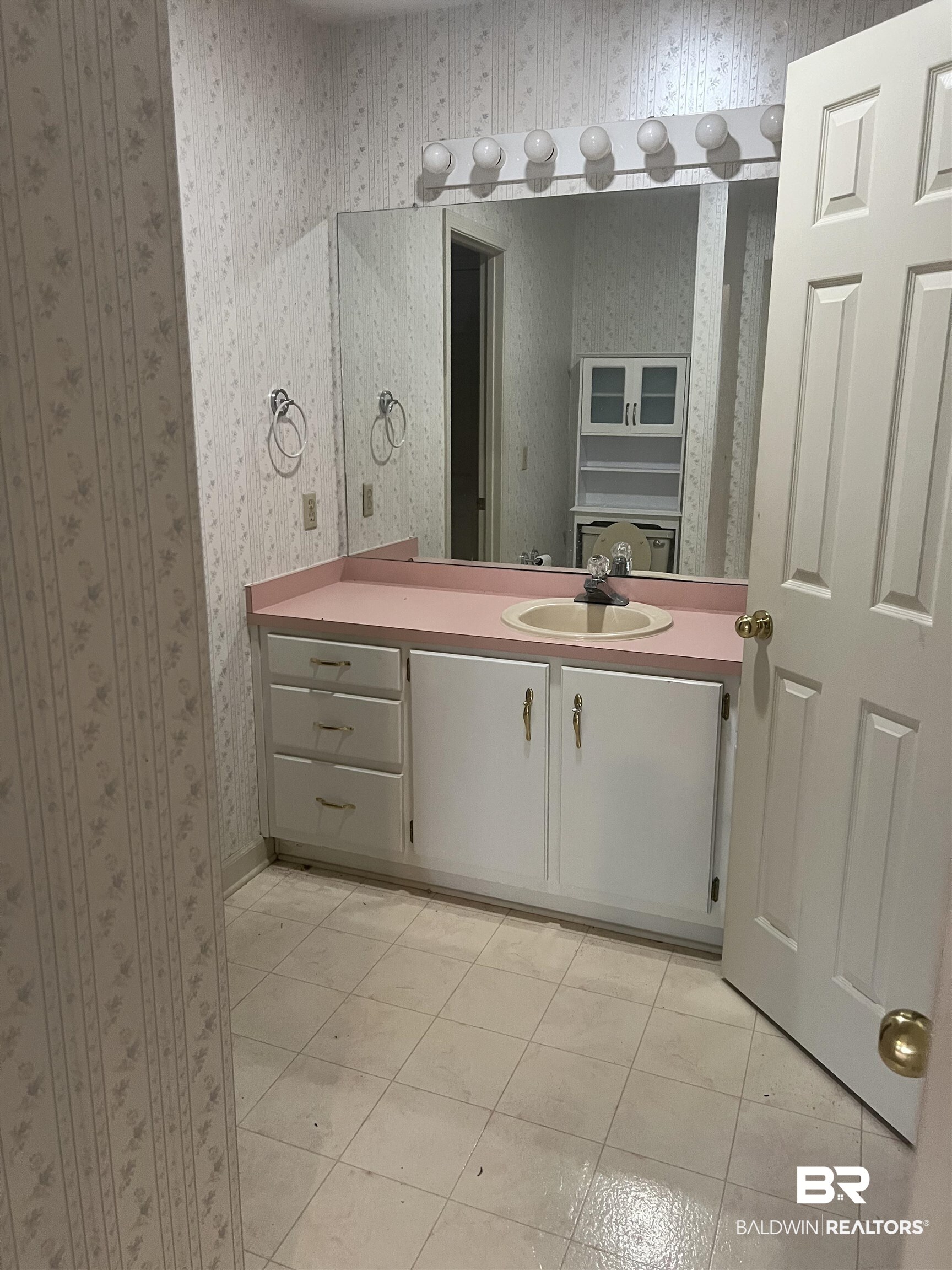 295 Norwood Road Monroeville, AL 36460 - Photo 16 of 32 Bathroom featuring wallpapered walls, vanity, and tile patterned floors
