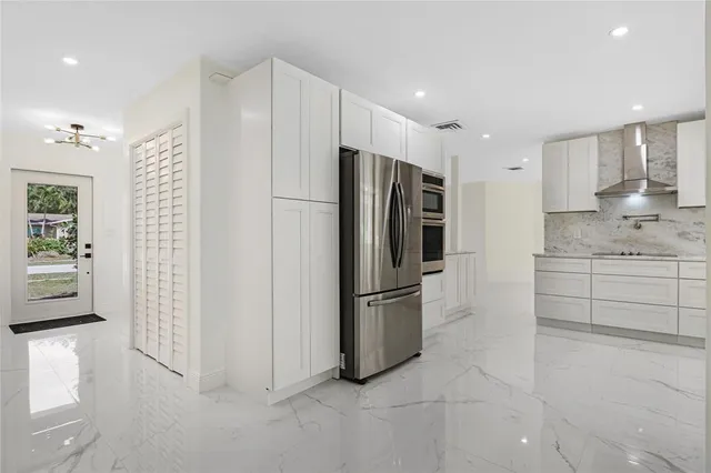 a kitchen with stainless steel appliances a refrigerator sink and cabinets