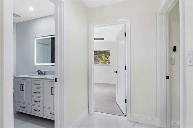 a en suite bathroom with a granite countertop sink a mirror and a