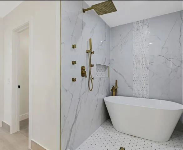 a bathroom with a bathtub and shower