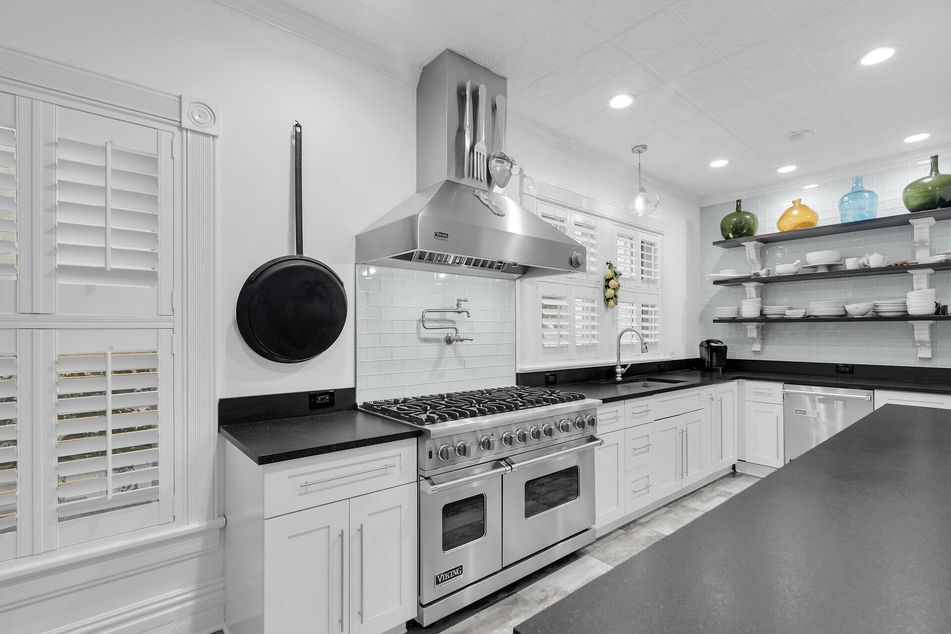 626 Grinnell Street Key West, FL 33040 - Photo 11 of 40 a kitchen with stainless steel appliances granite countertop a stove a sink and a microwave