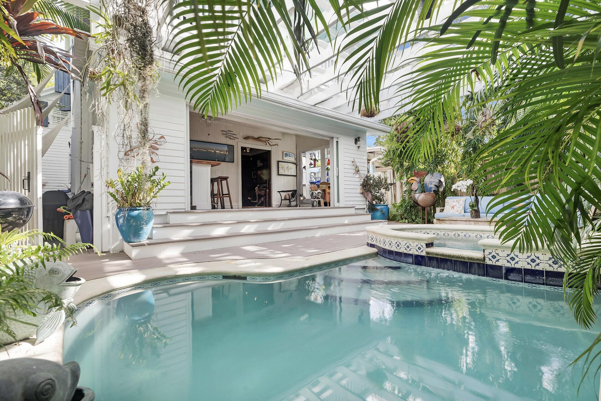 626 Grinnell Street Key West, FL 33040 - Photo 19 of 40 a view of a house with swimming pool and a garden