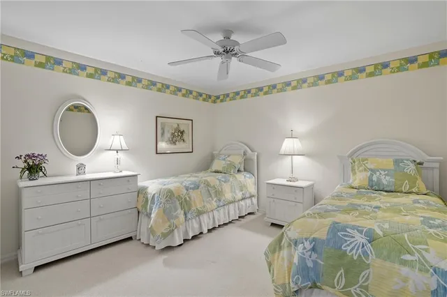 a bed room with two bed and a chandelier