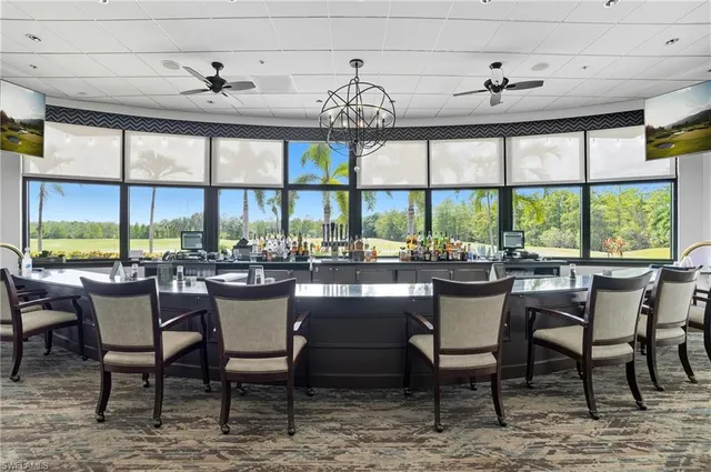 a dining room with furniture a chandelier and a rug