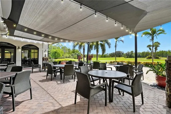 a view of a patio with a dining table and chairs