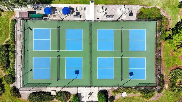 a green building with trees in front of it