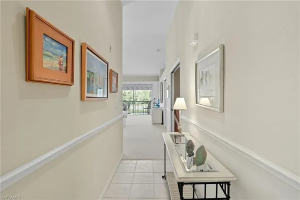 a hallway with a couch and chandelier