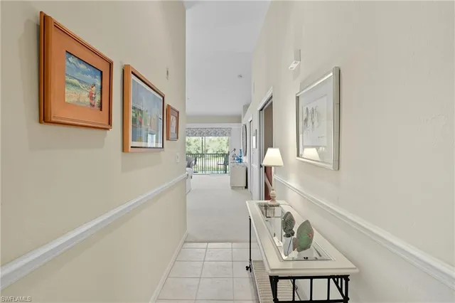 a hallway with a couch and chandelier
