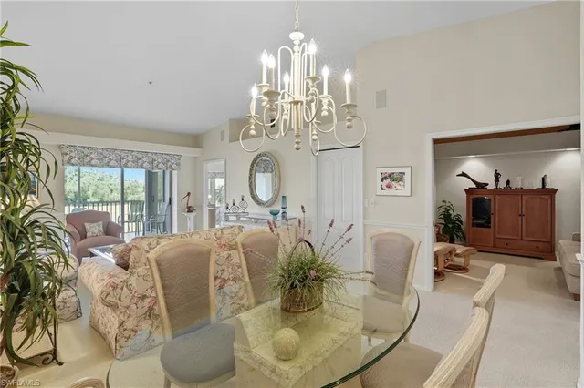 a living room with fireplace furniture and a chandelier
