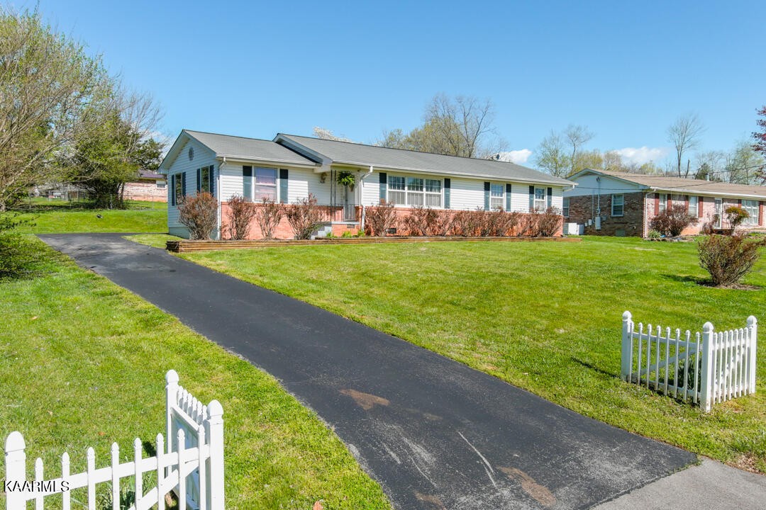 5409 Bluefield Road Knoxville, TN 37921 - Photo 1 of 33 a front view of a house with a yard table and chairs