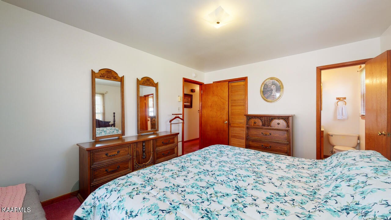 5409 Bluefield Road Knoxville, TN 37921 - Photo 20 of 33 a bedroom with a bed and a dresser with mirror