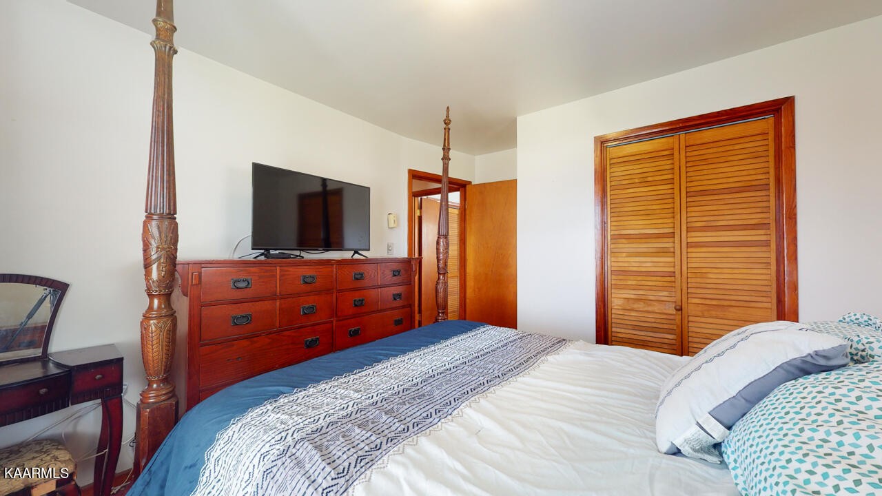 5409 Bluefield Road Knoxville, TN 37921 - Photo 23 of 33 a bedroom with a bed and a flat tv screen on dresser